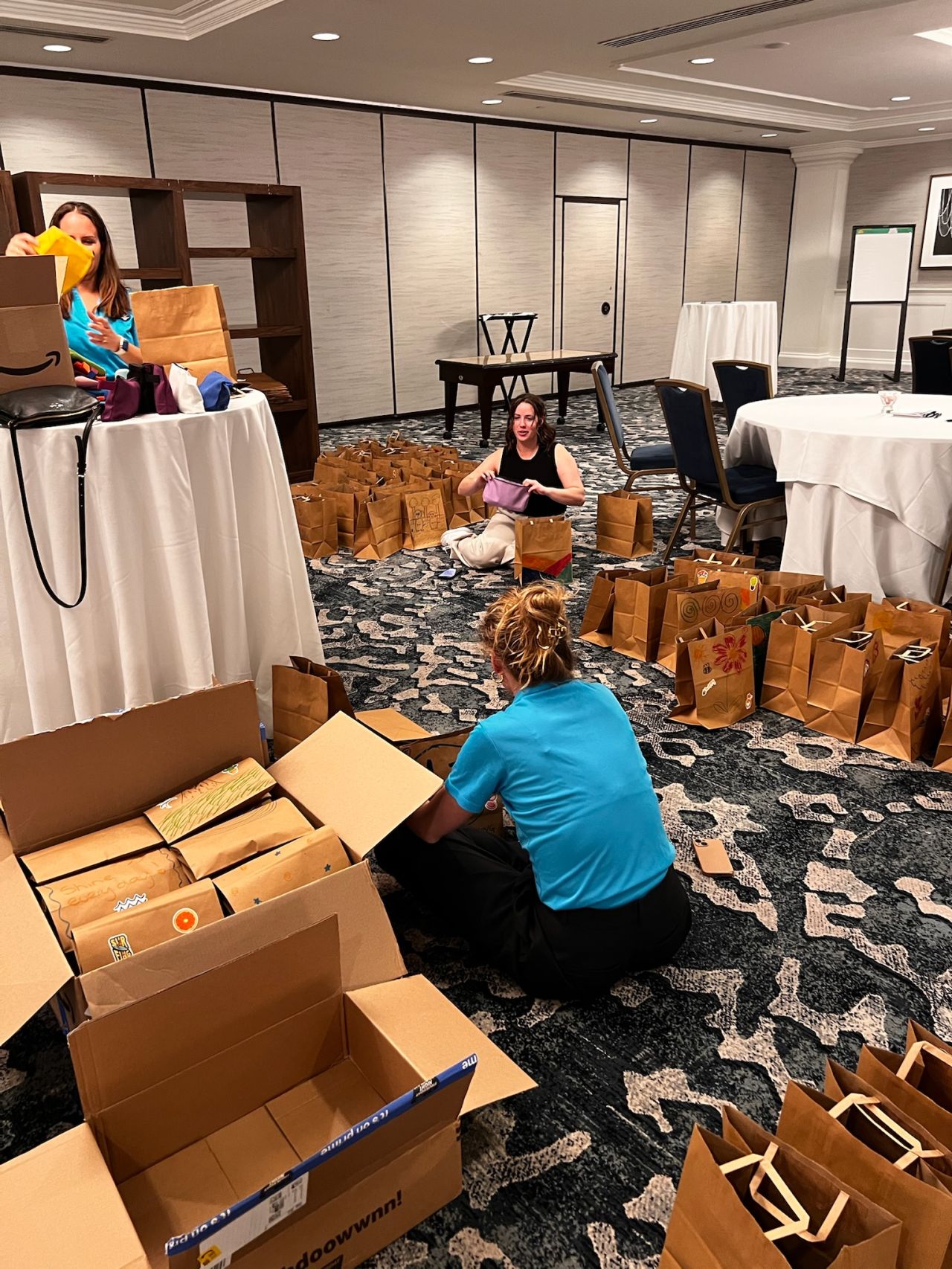 Build-a-Bag Corporate team collaborating on Build-a-Bag CSR challenge creating care packages for local community